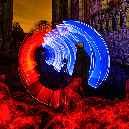 Tripping the Light Fantastic - A photorapher captures the Historic Bolton Abbey Priory surrounded by a kaleidoscope of colours .